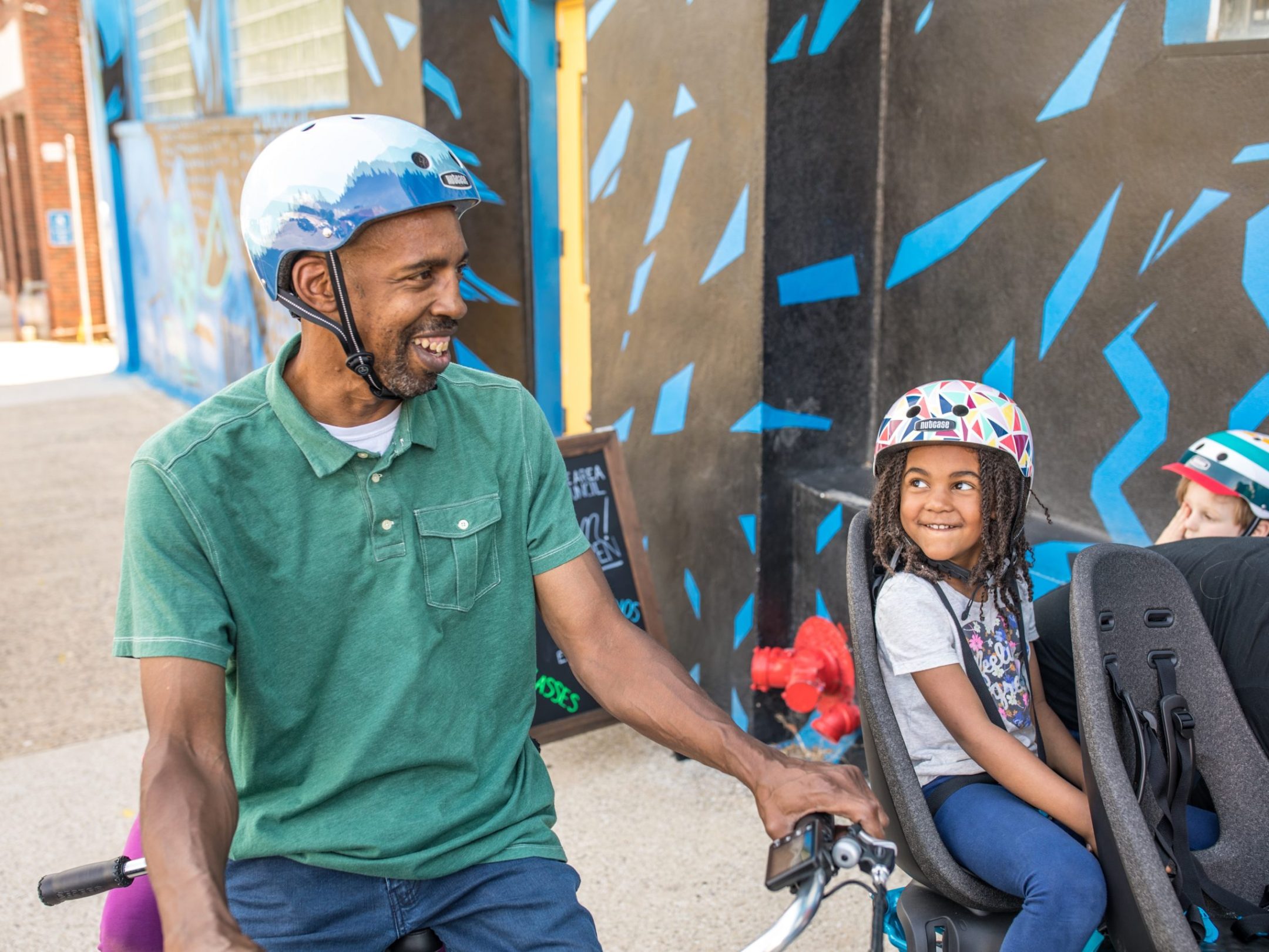 Father and daughter smiling during their fun family bike tour of Asheville, NC