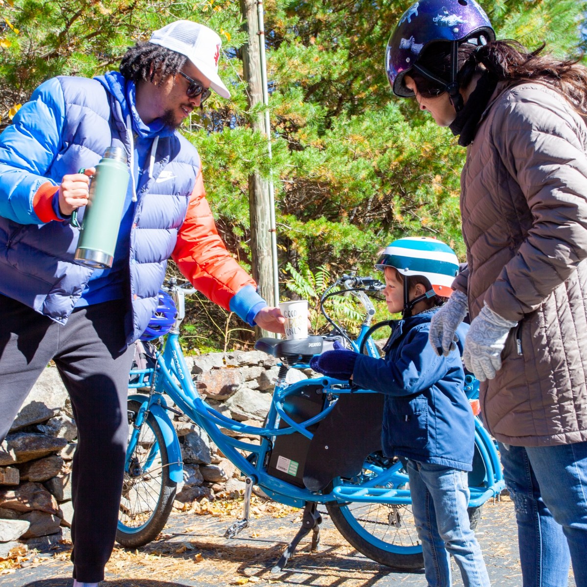 A family stopping for drinks during their family bike tour