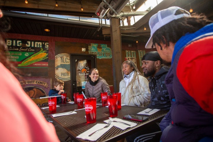 A group of people sitting at a table at a restaurant