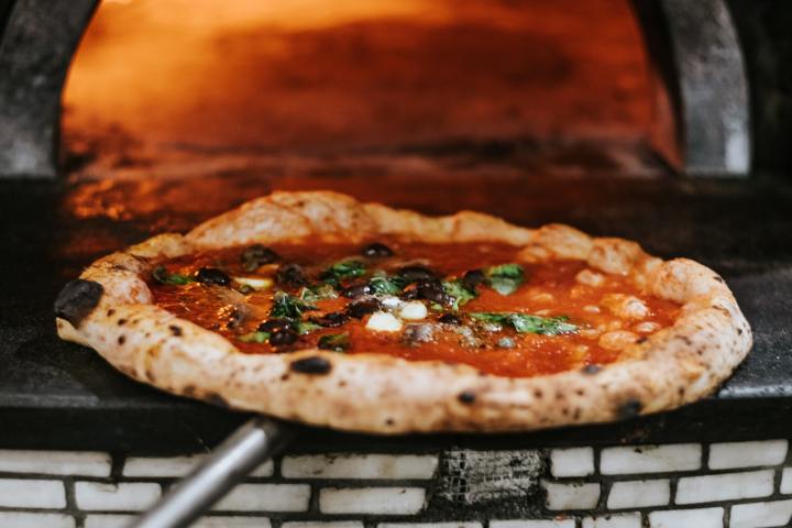 Pizza sitting on top of a pan on a stove top oven